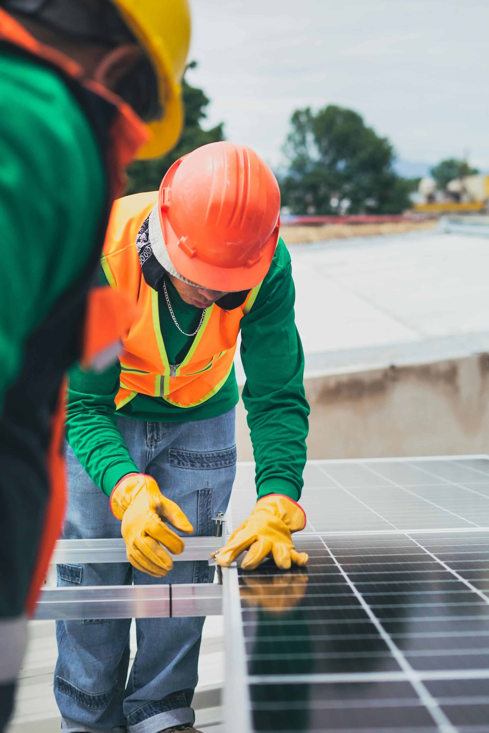 Workers installing a solar panel on a rooftop for clean energy