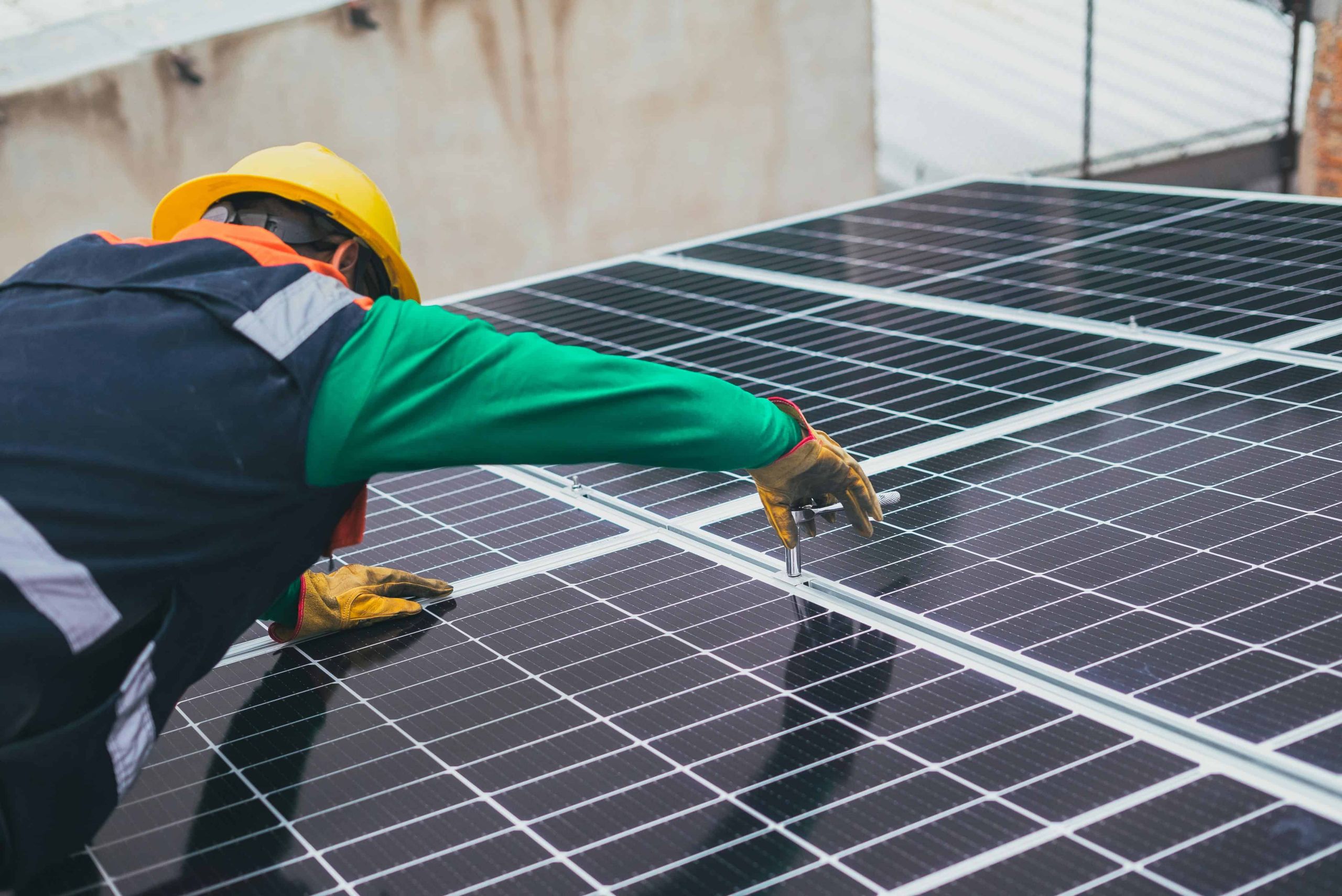 A man checking the solar panels.