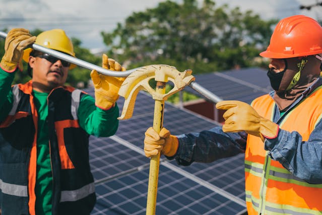 2 men installing solar panels.