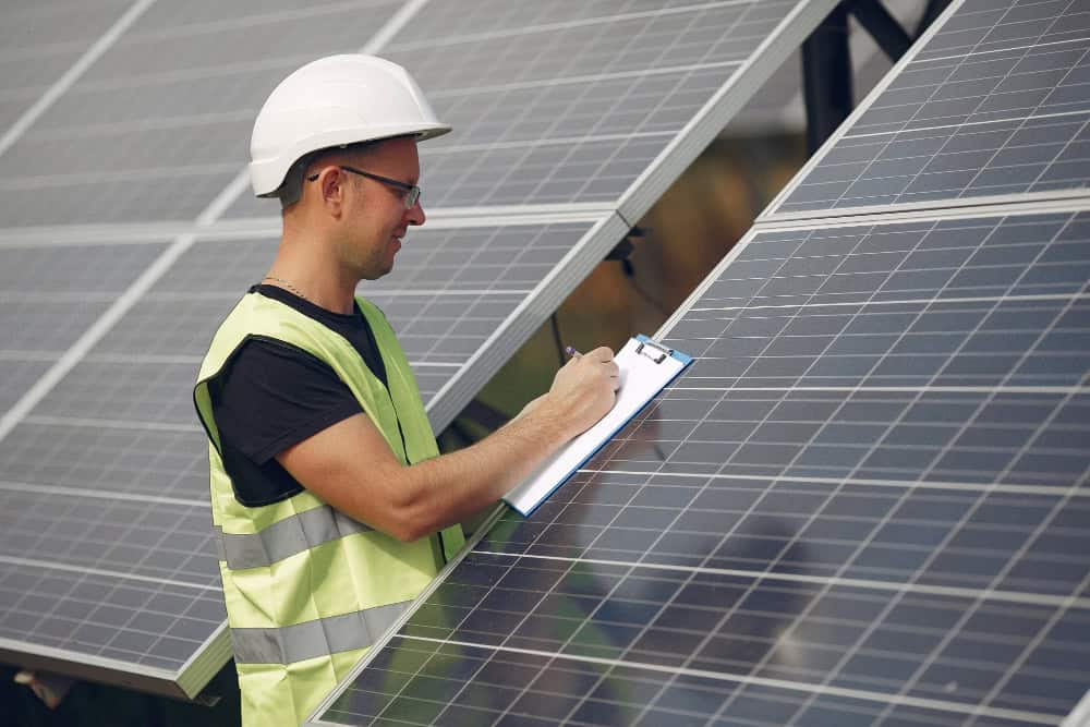 Solar panels installed on a rooftop with a clear blue sky in the background.