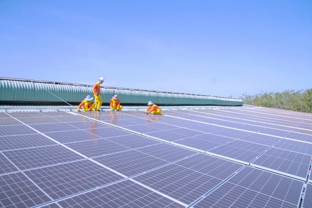 people working on solar panels.