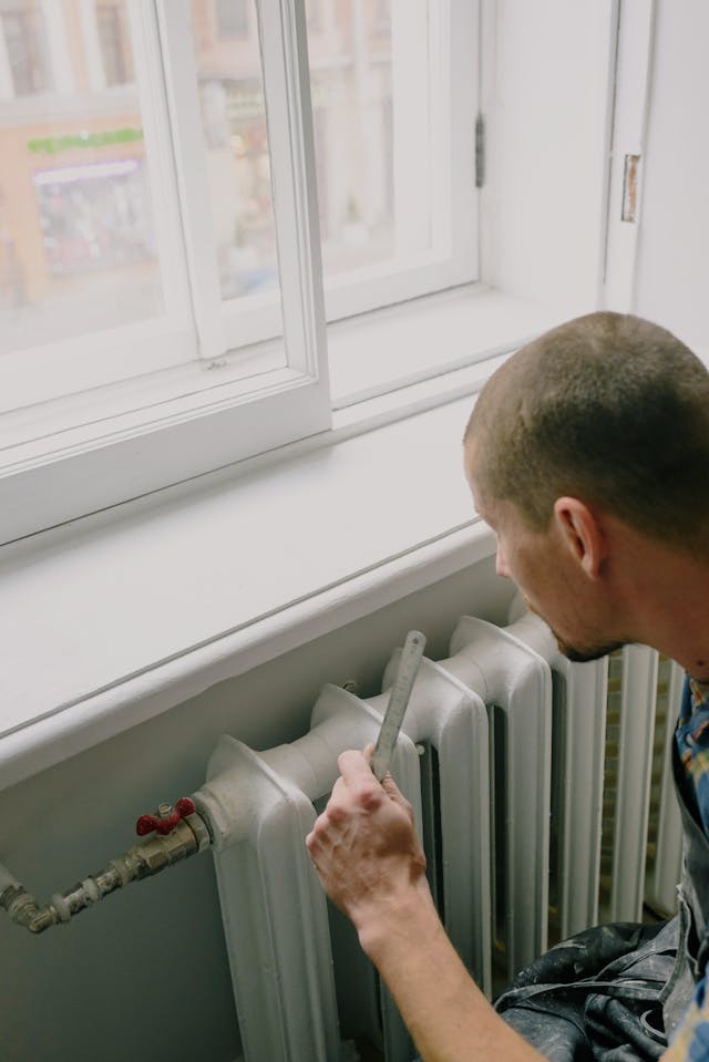 man setting up the hvac heater at a house.