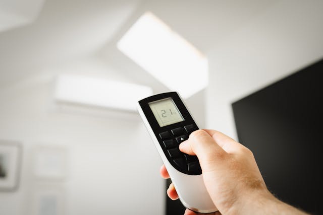 man setting temperature on an hvac system.